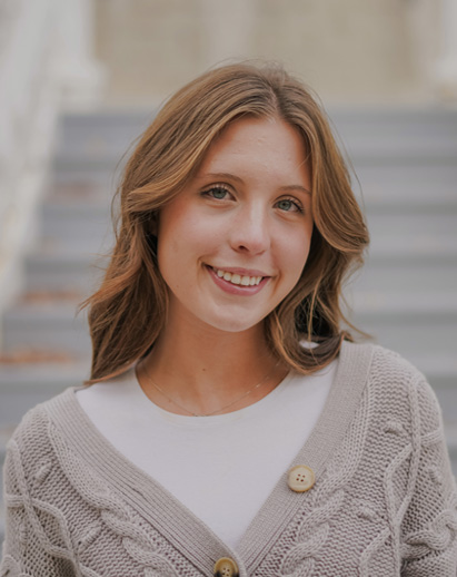 A photo of Mabel. She is a young white woman and is smiling.