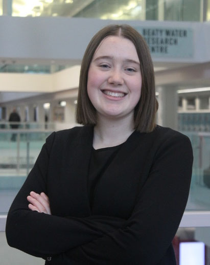 A photo of Nicole. She is a young white woman and is smiling.