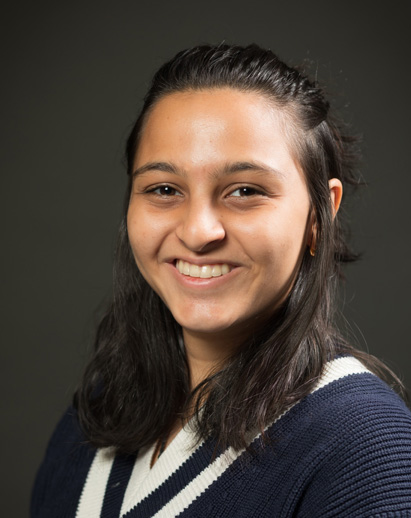 A photo of Riya. She is a young Southeast Asian woman and is smiling.